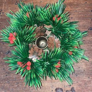 Vintage Christmas candle holder surrounded by pine cones & holly berries
